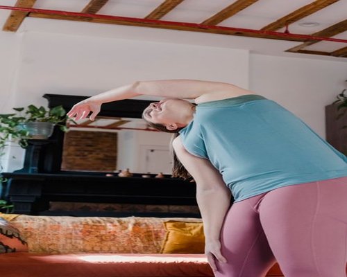 Person doing light stretching in their living room in Peru